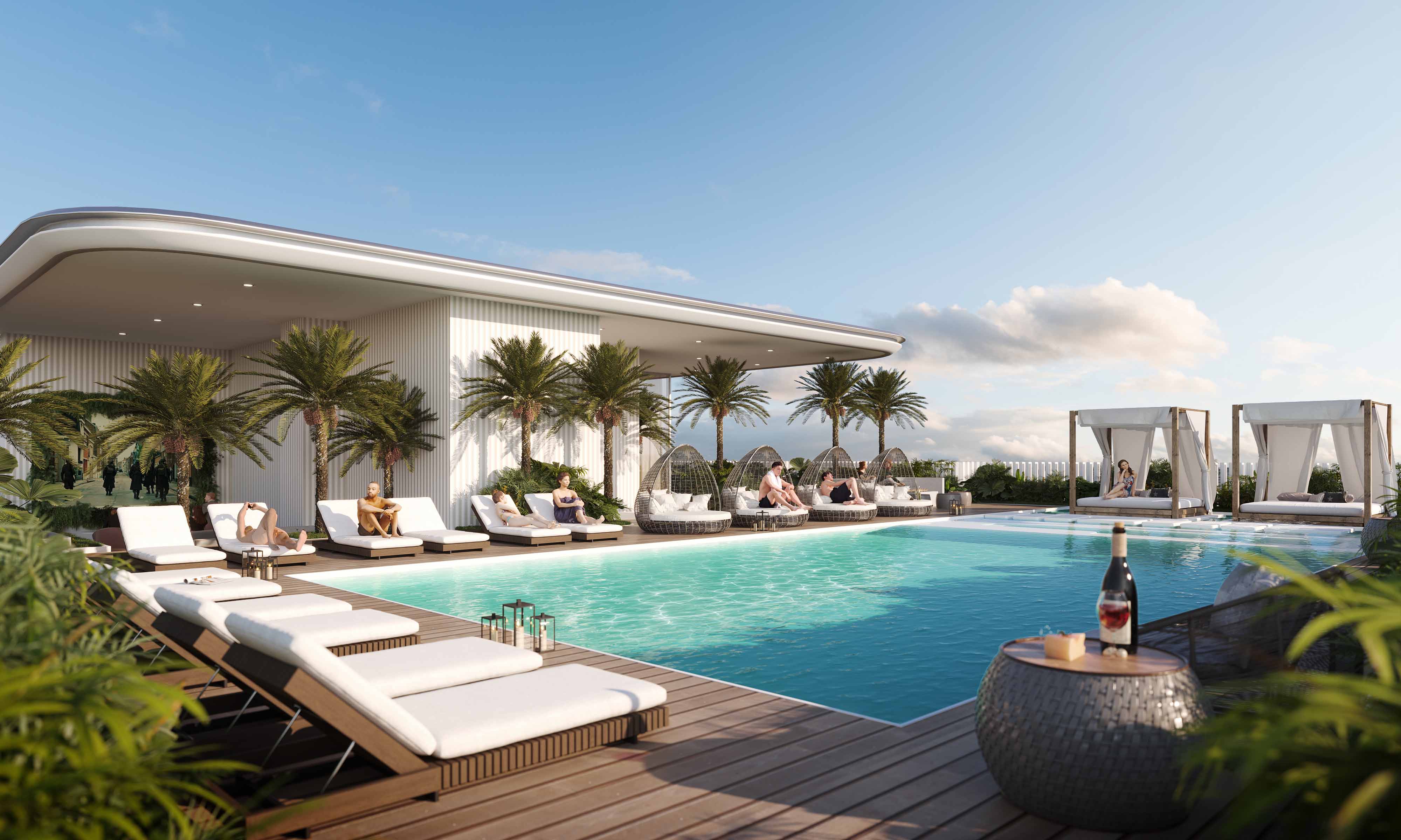 Cove Edition I By Imtiaz 1 A luxurious poolside scene featuring lounge chairs, palm trees, and stylish cabanas under a clear blue sky.